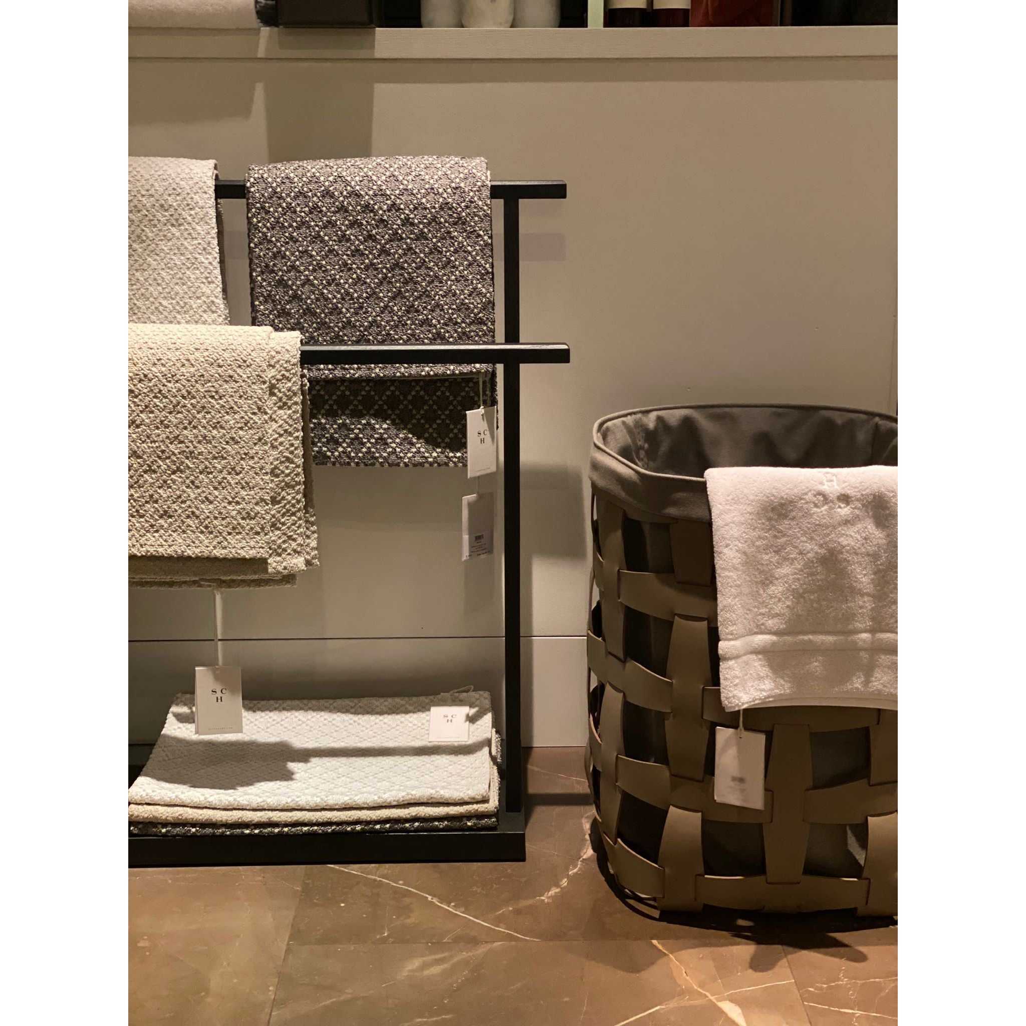 Scapa_Home_bath rugs and towels and Pinetti_laundry basket big hook taupe bathroom_setting