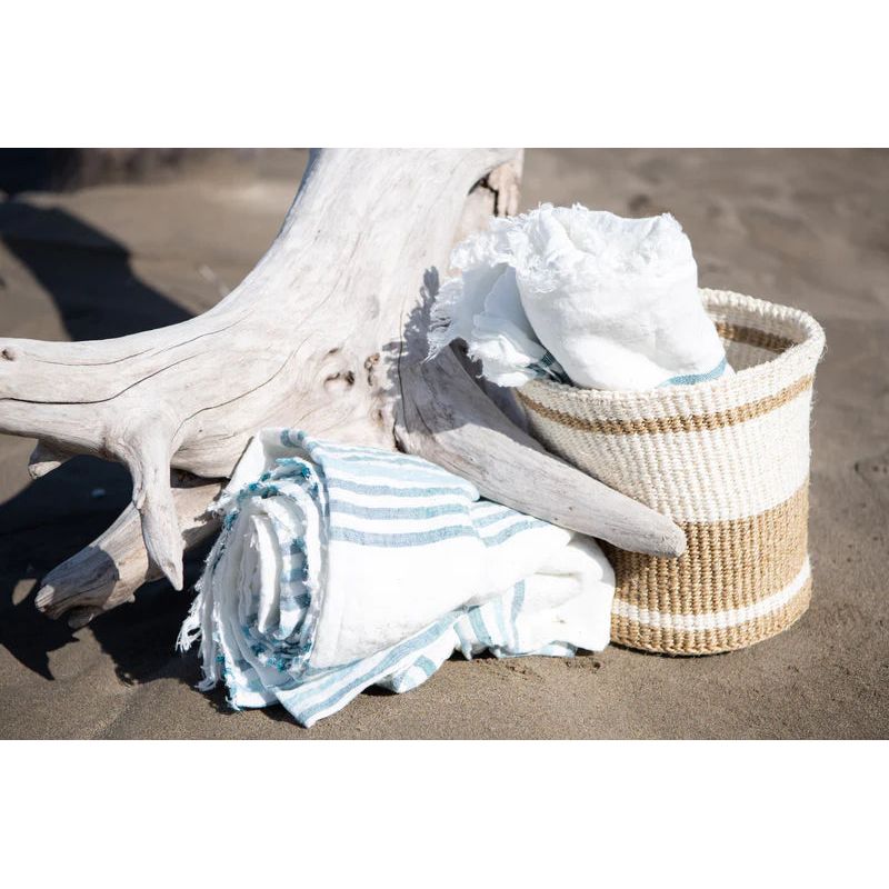 Scapa_Home_rattan_baskets_Taita and_beach_towel_beach_setting